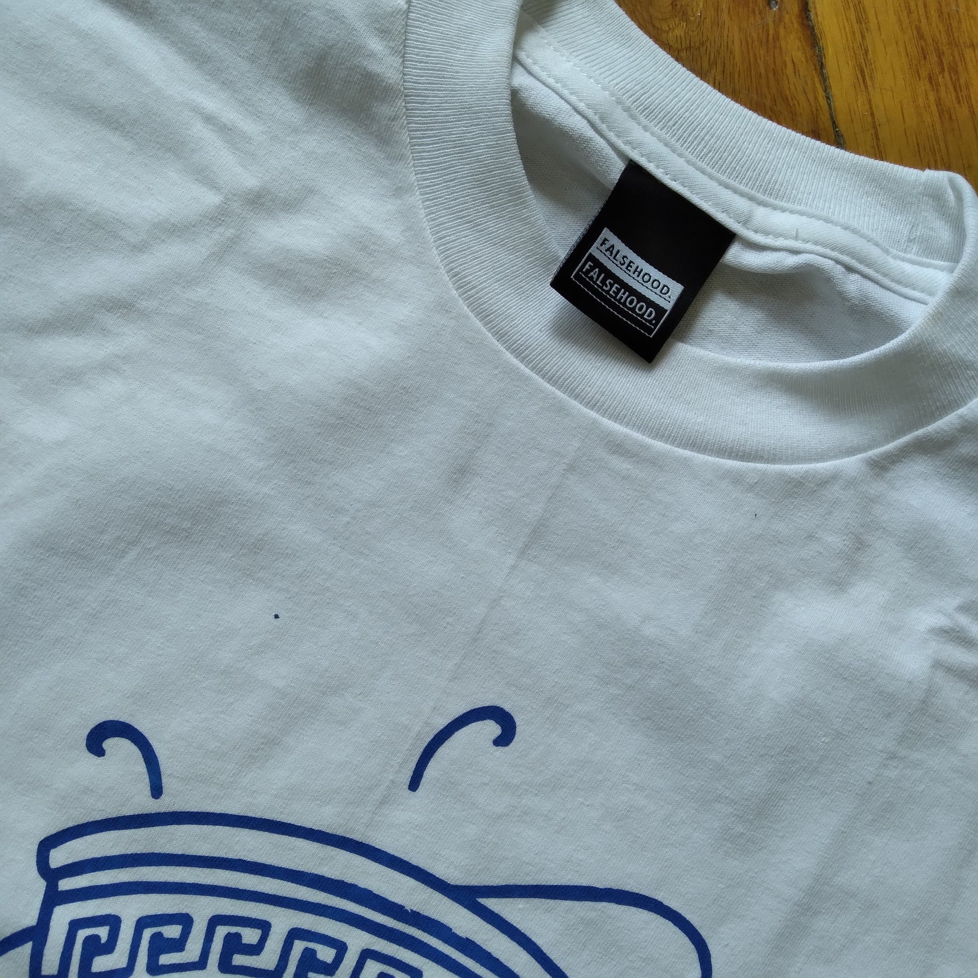 The TEA CUP. Tee - FALSEHOOD.