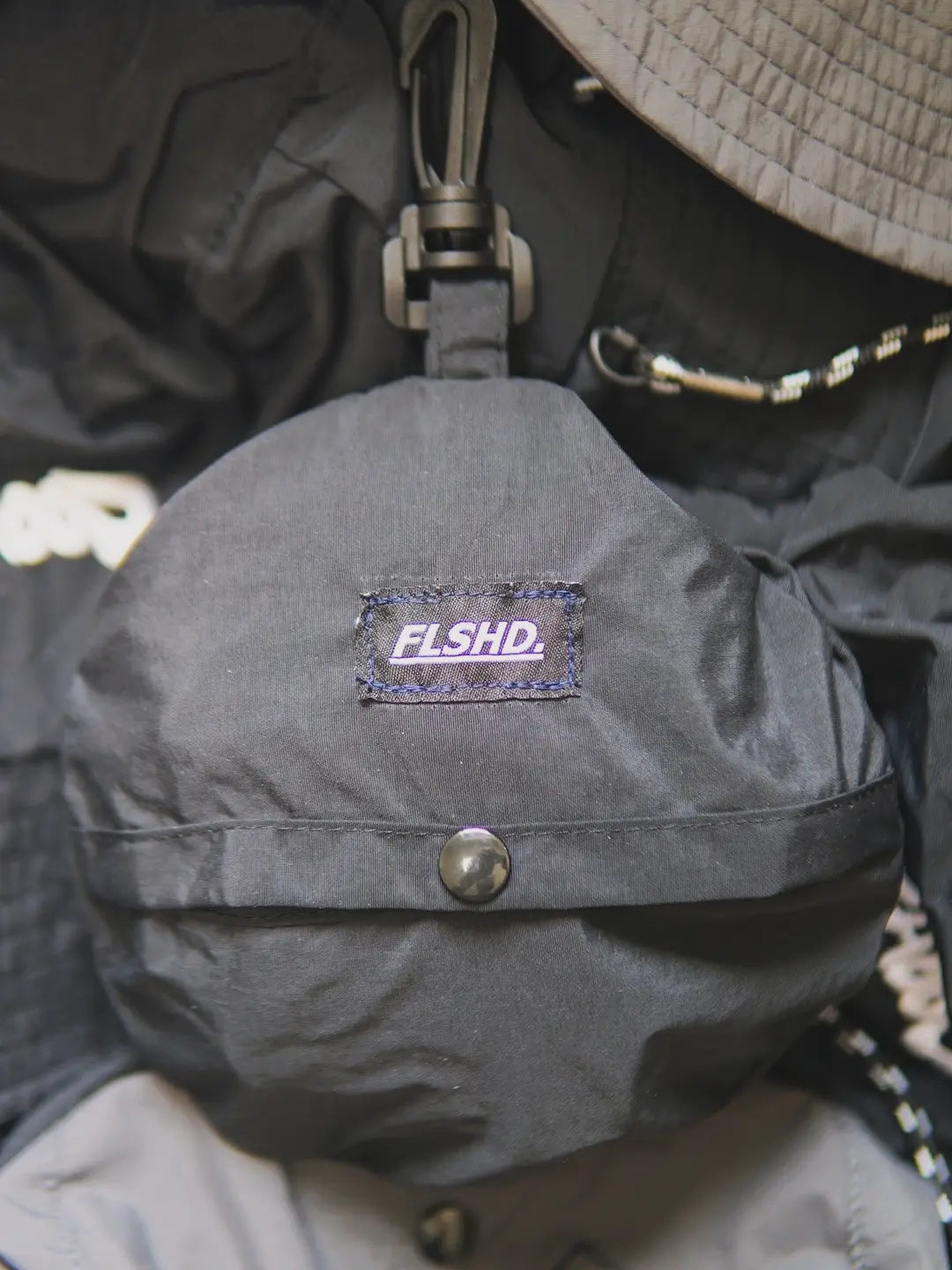The Big TAG. Runner Waterproof Bucket Hat - FALSEHOOD.