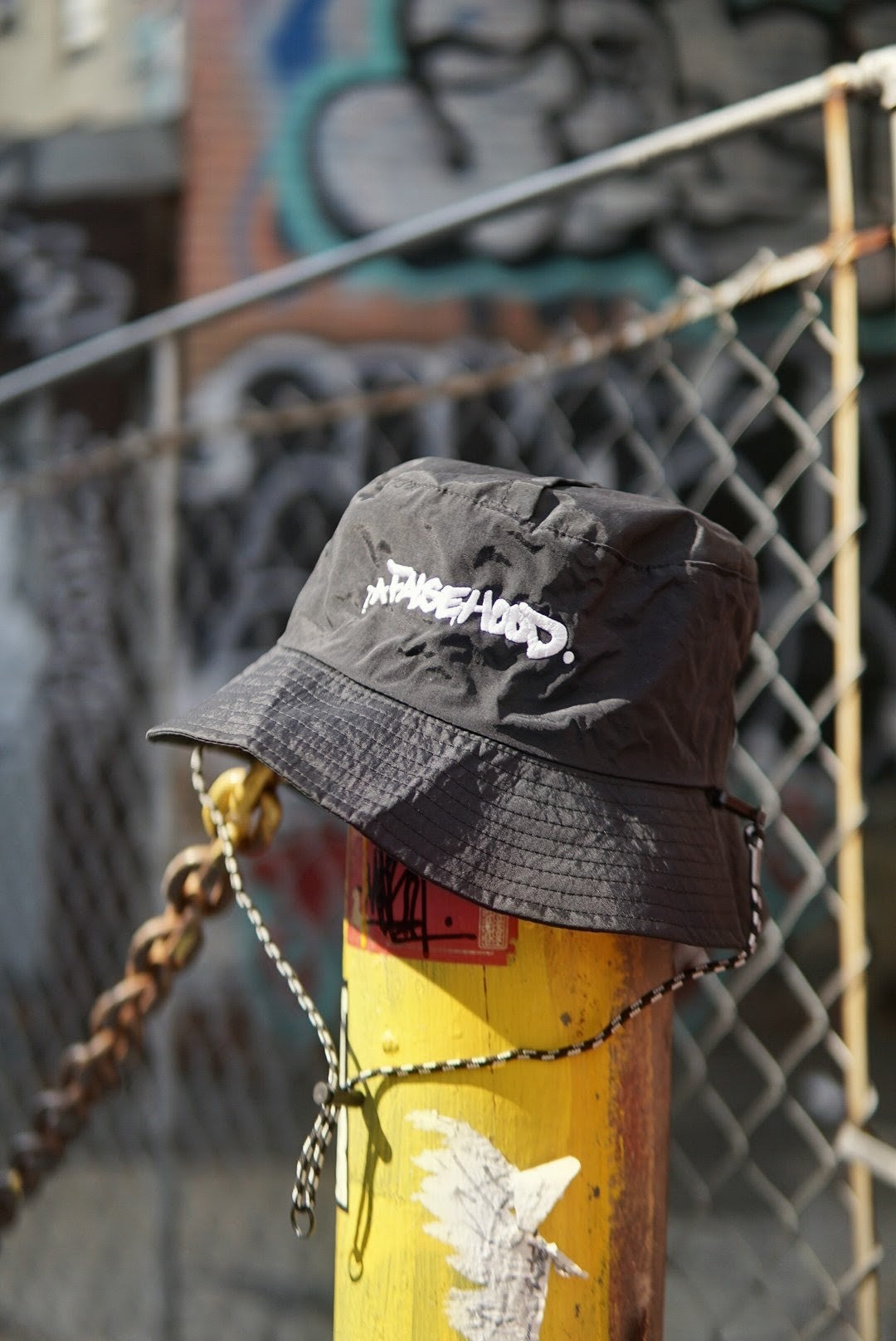 The Big TAG. Runner Waterproof Bucket Hat - FALSEHOOD.
